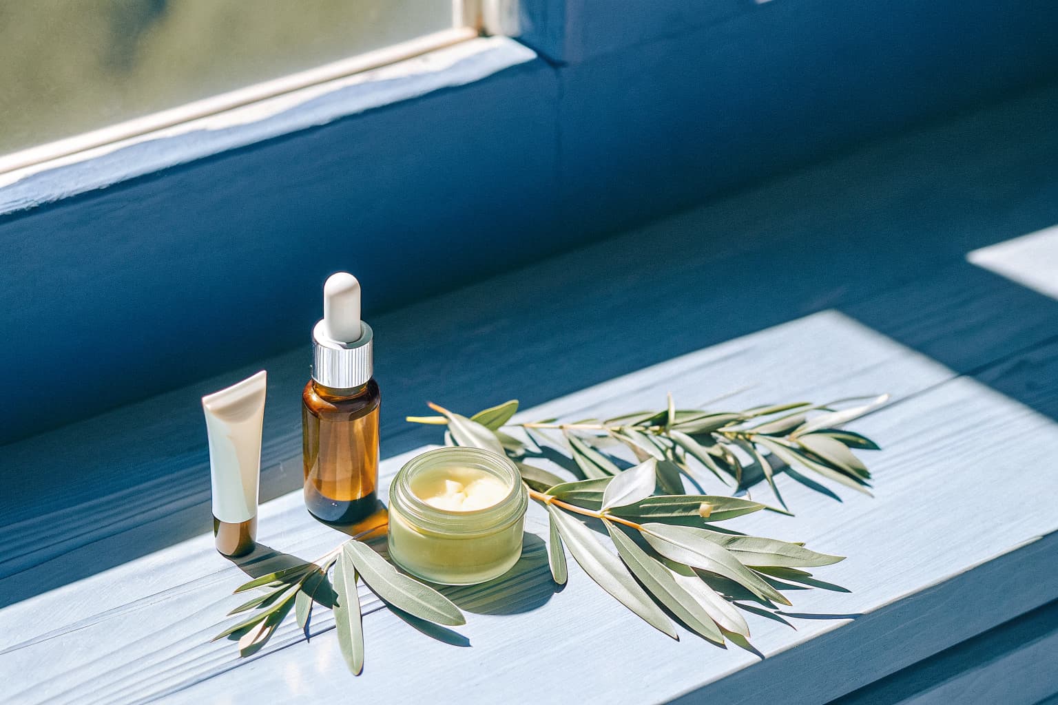 Natural wellness and skincare products including tincture, oil, sunscreen, and shea butter