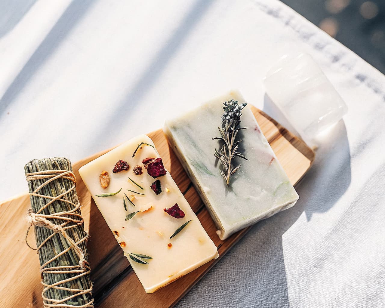 Intention soap bars with dried botanicals, rose petals, and sage for spiritual cleansing